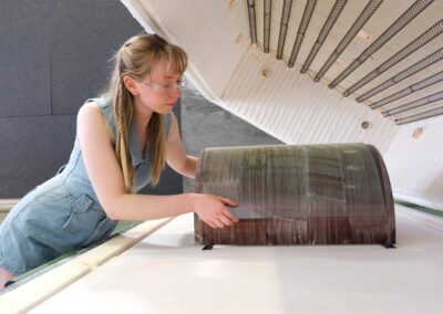 Artist, Bronte Cormican-Jones, removing glass sheet from kiln