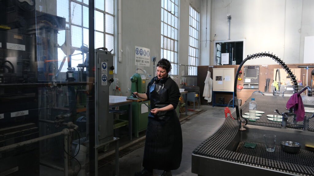 Artist, Lisa Sammut, standing in the middle of the Coldshop at Canberra Glassworks