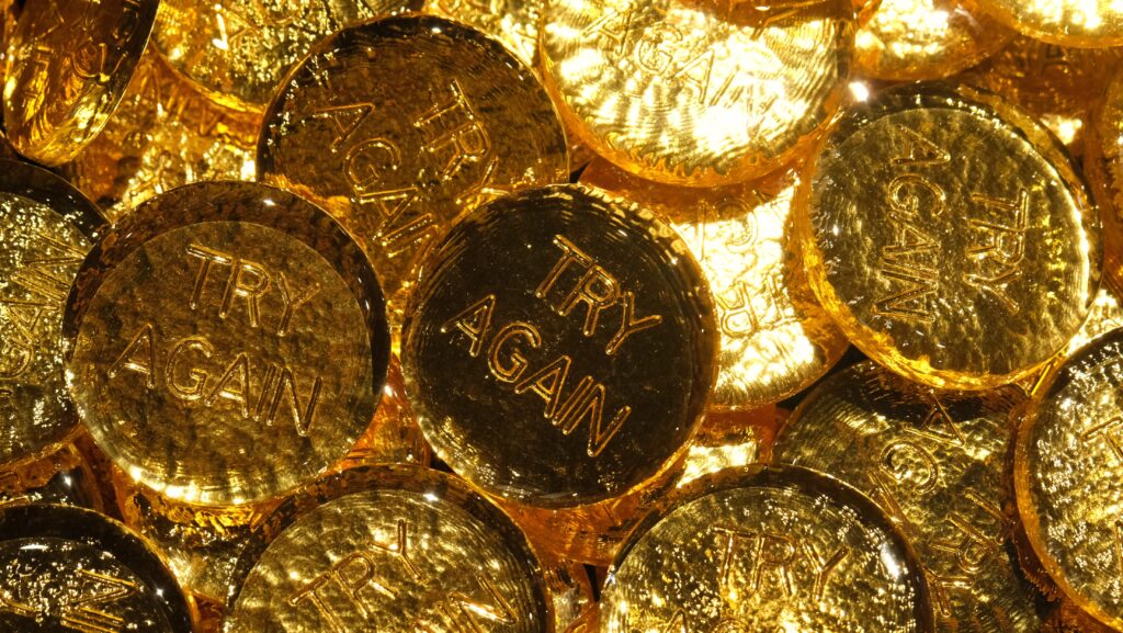 Glass gold leaf coins with 'TRY AGAIN' stamped on them