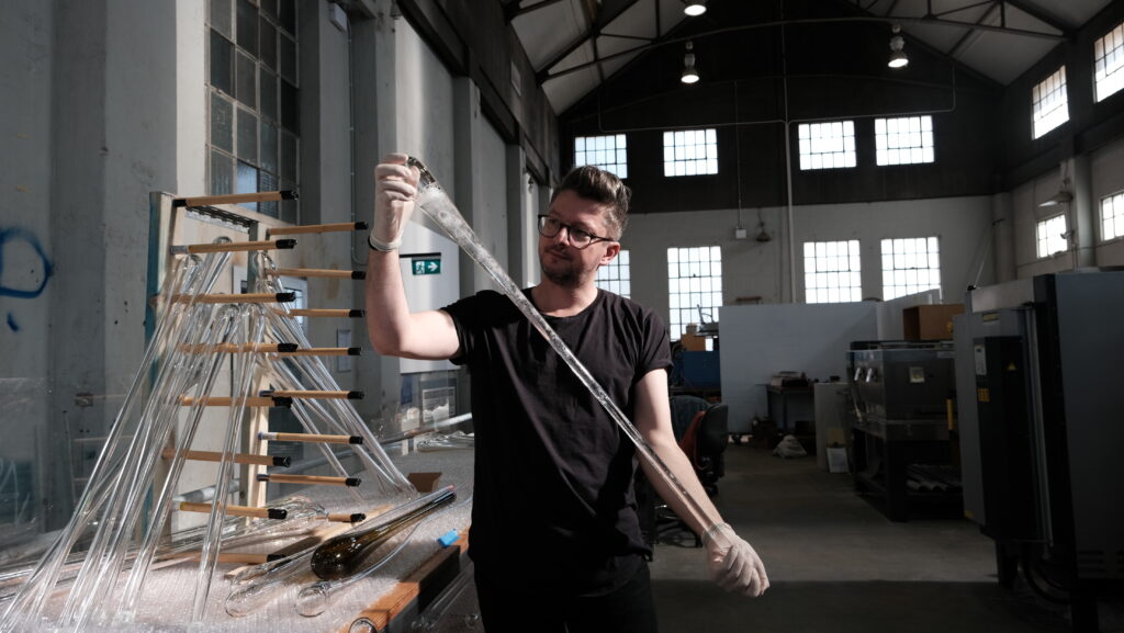 Artist Alex Seton cleaning glass chandelier elements