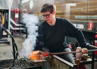 Katie-Ann Houghton, working in the hotshop at the Canberra Glassworks. Photo by Pew Pew Studio for ArtsACT